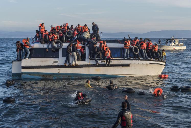 Syrian and Iraqi refugees arrive from Turkey to Lesbos, Greece.